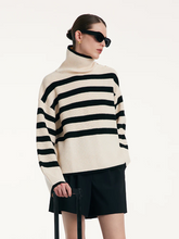 a lady wearing a loose-fit striped button-shoulder sweater